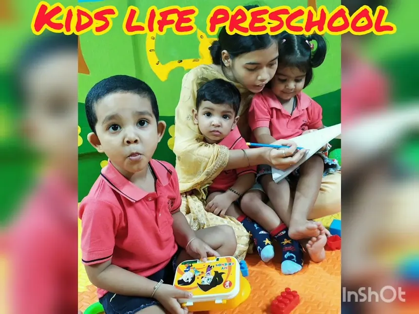 Teacher reading with little learners at Kids Life School